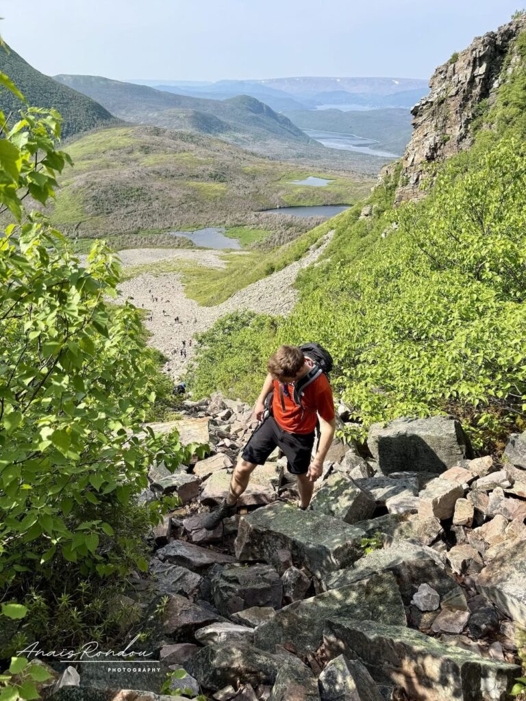 Personne qui grimpe sur les rochers de l'éboulis du Mont Gros-Morne